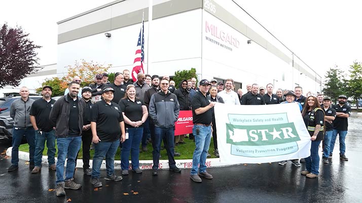 Group photo of Milgard Pultrusion employees raising the STAR flag.