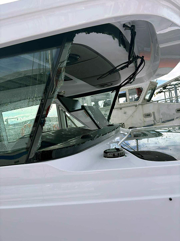 U.S. Coast Guard photo shows the boat’s windshield shattered by six-foot waves.