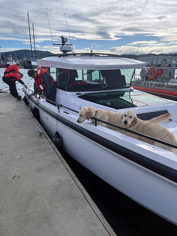 U.S. Coast Guard photo shows two dogs rescued along with their owners from a boat hit by high winds and waves.