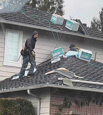 L&I photo shows Allways Roofing workers re-roofing a two-story home in Mill Creek with no fall protection system in place.